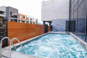 a hot tub on the side of a building at Dili Town Resort and Spa in Dilijan