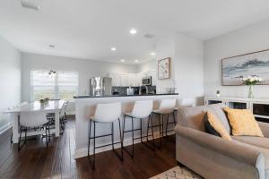 a kitchen and living room with a bar and a couch at St Augustine Rose Ocean Heated Private Pool in Saint Augustine +38 photos