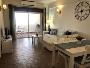 a living room with a couch and a table at Apartamento Oceano in Albufeira