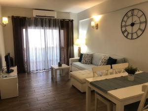 a living room with a couch and a table at Apartamento Oceano in Albufeira +30 photos