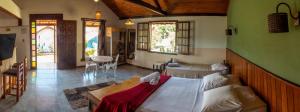 a bedroom with a large bed in a room at Pousada Barriga da Lua in Serra do Cipo