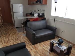 uma sala de estar com um sofá e uma mesa em Lima Flats em Lima