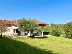 a house with a gazebo in a yard at Paradise - nature and wellness in Pino Torinese