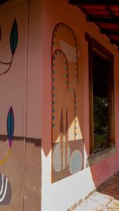 a play house with a sign on the side of it at Pousada Barriga da Lua in Serra do Cipo