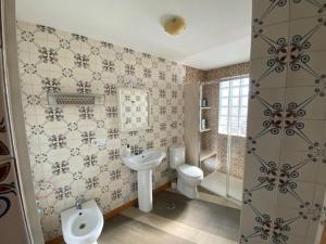 a bathroom with a sink and a toilet and a shower at Lar dos Galos in Bueu +27 photos