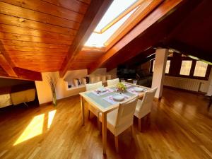a dining room with a table and white chairs at Paradise - nature and wellness in Pino Torinese