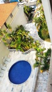 an overhead view of a blue pool on a patio with palm trees at Apartamento Top Expo Center Norte Paulista Centro in Sao Paulo