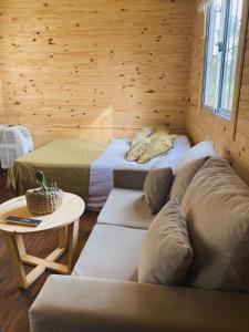 a room with two beds and a table in a room at Campo verde II in Concordia