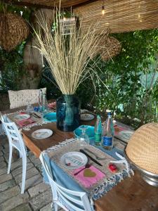 a wooden table with plates and dishes on it at B&B CAVOUR 117 in Porto SantʼElpidio
