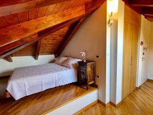 a bedroom with a bed and a wooden ceiling at Paradise - nature and wellness in Pino Torinese