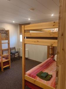 a room with two bunk beds and a chair at Route House 39 Motel in Jõgeva