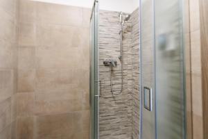 a shower with a glass door in a bathroom at Affittacamere Flavia Roma in Ostia Antica +30 photos