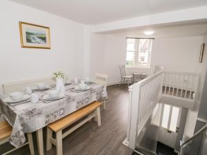 a dining room with a table with a table cloth on it at Hand Apartment in Llanrwst