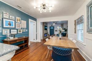 a dining room with a wooden table and blue walls at Blue Haven Beach Hot Tub History in Saint Augustine