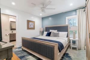 a bedroom with a large bed with a blue wall at Blue Haven Beach Hot Tub History in Saint Augustine