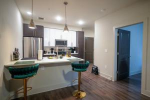 a kitchen with a counter and two bar stools at COZY 1 bed/1 bath in Atlanta
