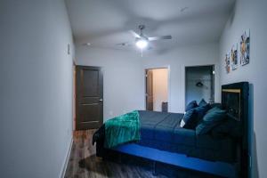 a bedroom with a blue bed and a ceiling fan at COZY 1 bed/1 bath in Atlanta