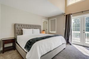 a bedroom with a large bed and a window at Washington Retreat with Balcony, Patio and Fire Pit! in Seattle