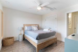 a bedroom with a bed with a ceiling fan at Treehouse By the Sea in St. Augustine