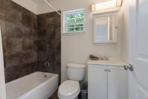 a bathroom with a toilet and a tub and a sink at Whitefish Lodge in St. Augustine +25 photos