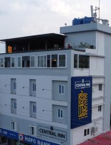 a large white building with a sign on it at CENTRAL INN in Dibrugarh