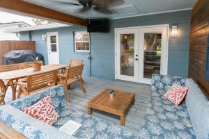 a patio with a table and a couch and a table at Captains Quarters Island location Hot tub One Level in St. Augustine