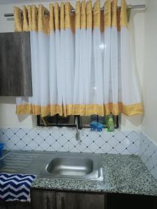 a kitchen with a sink and a window at DANA HOMES in Nairobi