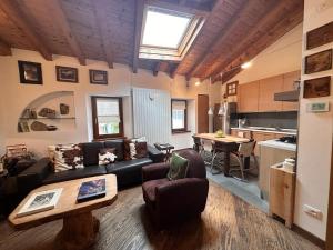 a living room with a couch and a table at Nido Mountain Apartment in Castione della Presolana