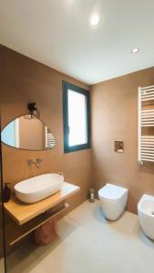 a bathroom with two sinks and a toilet at Casa di Pino in Cefalù