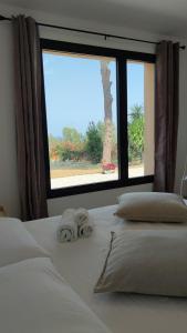 a bedroom with a bed with a large window at Casa di Pino in Cefalù