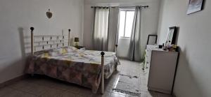 1 dormitorio con 1 cama, vestidor y ventana en Lexa Guest Apt, en Praia