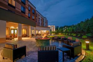 a courtyard with chairs and a fire pit in front of a building at Courtyard by Marriott Wilkes-Barre Arena in Wilkes-Barre