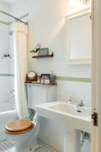 een witte badkamer met een toilet en een wastafel bij 1890 CapeCod farmhouse:Charming, Private, Spacious in Saugerties