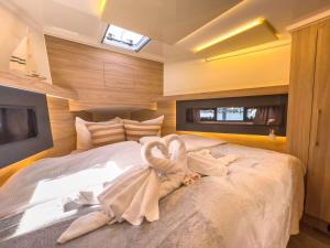 a bedroom with a large bed with a swan on it at Motoryacht-Futura-Urlaub-im-Yachthafen in Burgtiefe auf Fehmarn 