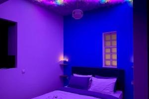 a purple bedroom with a bed and a purple wall at Olympus' gods/ near Acropolis/S.A.X. in Athens