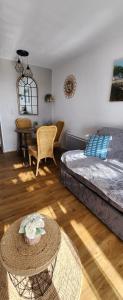 a living room with a bed and a table at Saint-Raphael- Vue mer et Massif de l'Esterel in Saint-Raphaël