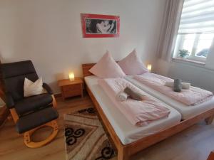 a small bedroom with a bed and a chair at Haus-Wolter in Goslar