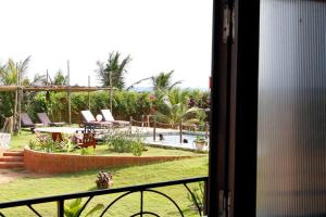 a view of a swimming pool from a balcony at La Maison Bleue Lome in Lomé