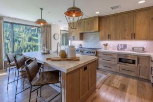 a kitchen with wooden cabinets and a large island at The Snowpine Lodge in Alta