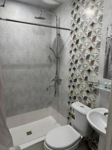 uma casa de banho com um chuveiro, um WC e um lavatório. em SEMURG HOTEL em Tashkent