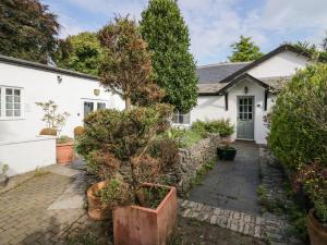 a house with a tree in front of it at Clarence House in Dalton in Furness