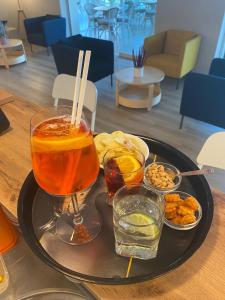 a tray of food on a table with a drink at Hotel Costa Verde in Pineto