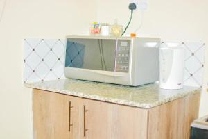 a microwave sitting on top of a counter at DANA HOMES in Nairobi +15 photos