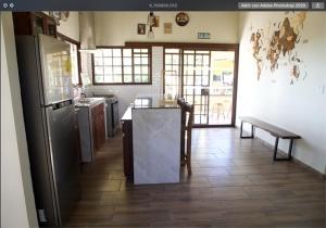 a kitchen with a refrigerator and a table in it at Noelle’s House - Alto Boquete, a natural place to enjoy. in Alto Boquete