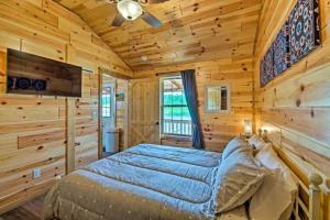 a bedroom with a bed in a wooden room at Mammoth Cave Cabin Rentals 9 in Cub Run
