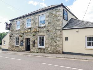 an old stone building on the corner of a street at Lemon Tree in Falmouth