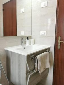 a bathroom with a white sink and a mirror at Paradiso Marino in Scalea +16 photos