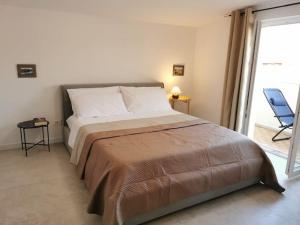 a bedroom with a bed and a chair and a window at Paradiso Marino in Scalea