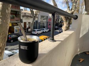 a cup of coffee sitting on a ledge at Costa Rica Soho Rooms in Buenos Aires