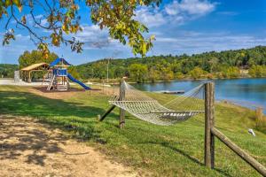a hammock in a park next to a lake at Mammoth Cave Cabin Rentals 1 in Cub Run